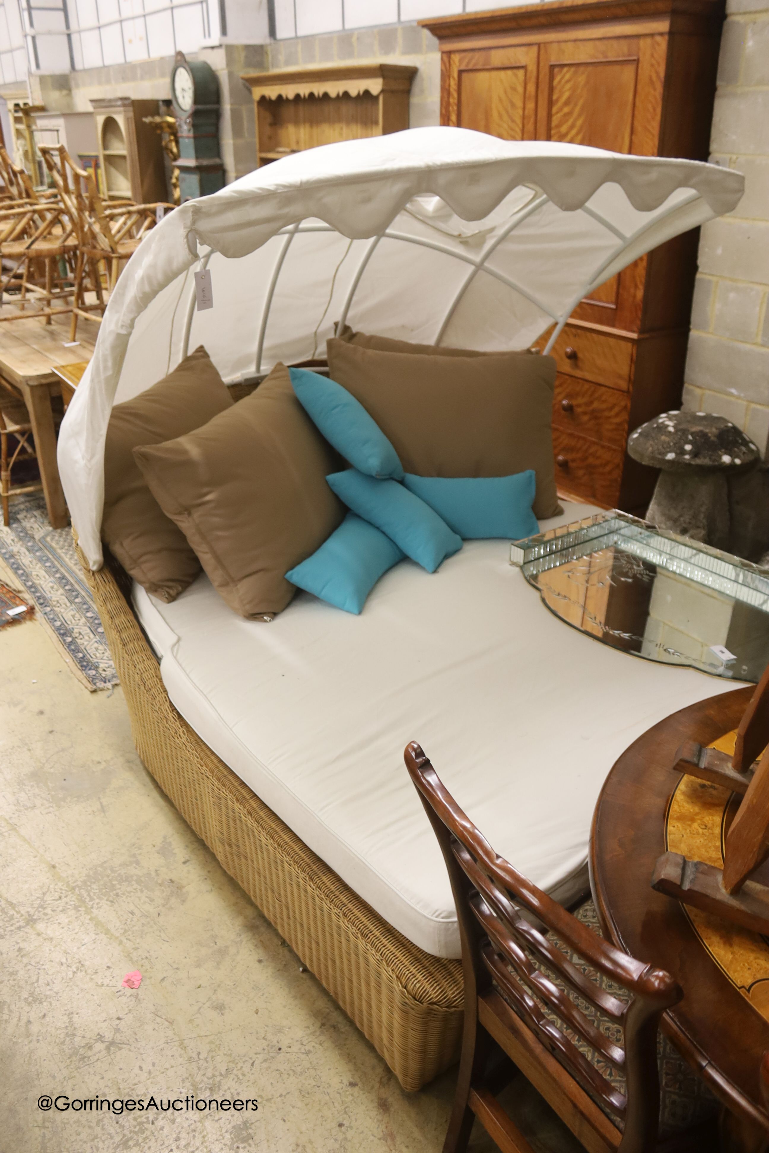 A Bevan Funnel All Weather rattan double garden daybed with metal canopy, mattress and cushions, approx. length 210cm, depth 160cm, height 166cm
